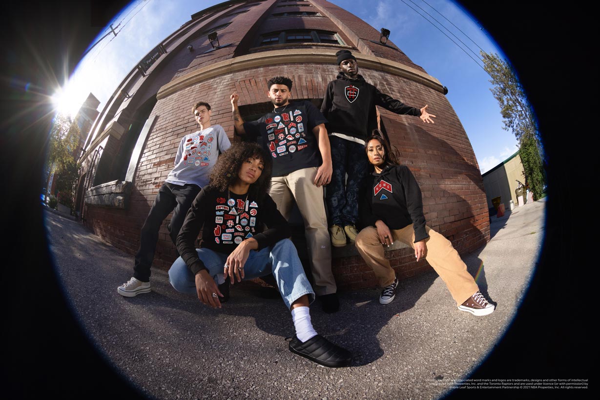 Group of people wearing homecoming collection merch